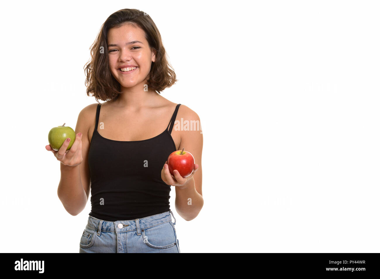 Young happy Caucasian teenage girl smiling holding red and green Stock Photo