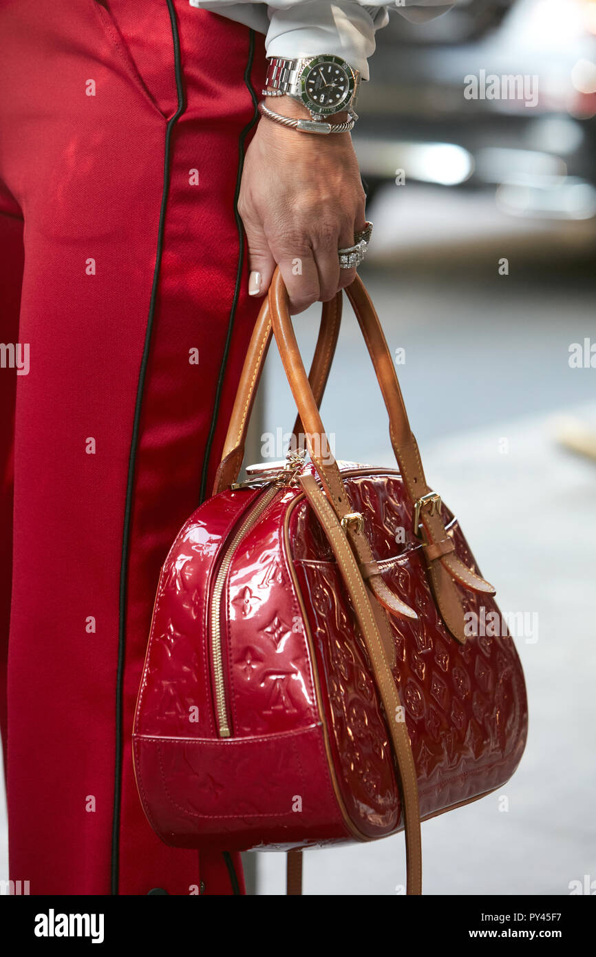 MILAN, ITALY - SEPTEMBER 23, 2018: Woman with red Louis Vuitton bag and  green Rolex Submariner watch before Giorgio Armani fashion show, Milan  Fashion Stock Photo - Alamy