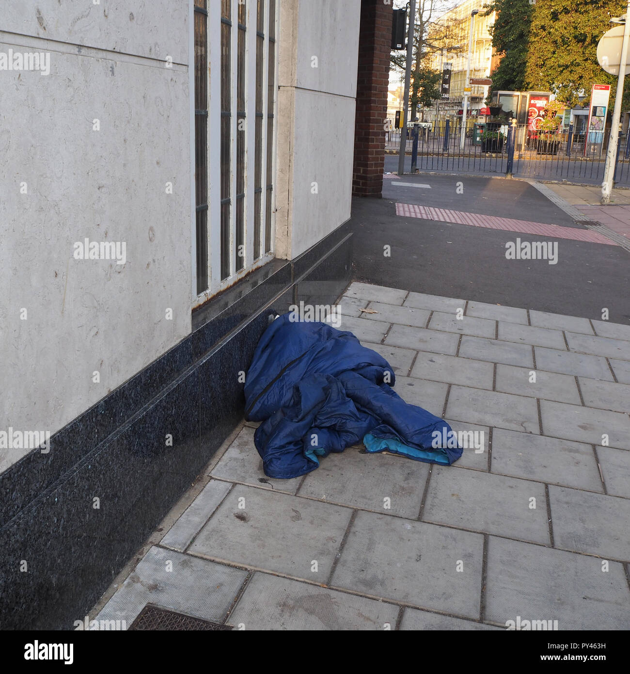 Discarded sleeping blanket left on the high street Stock Photo