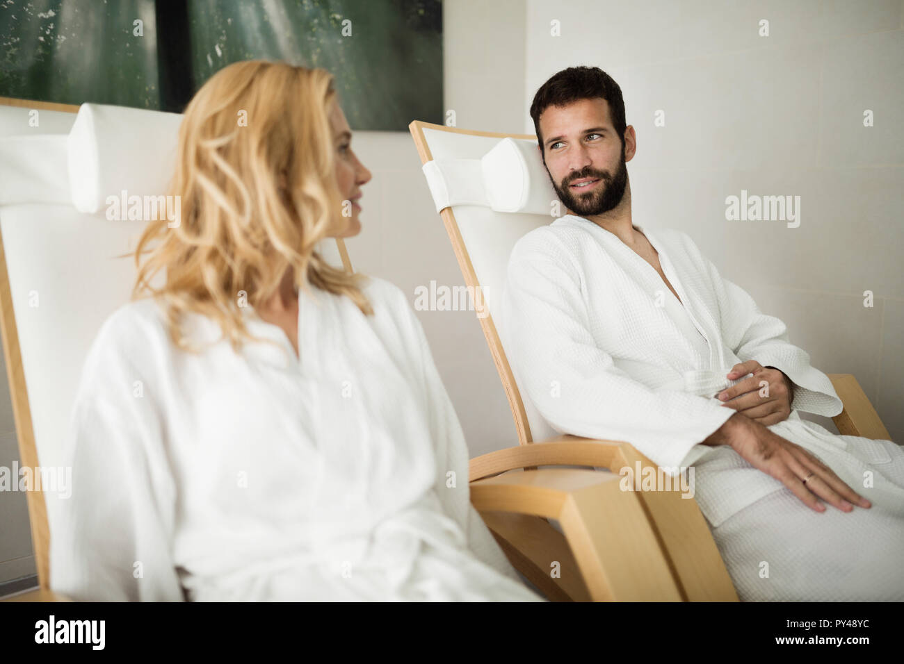 Beautiful woman and handsome man relaxing in spa center Stock Photo