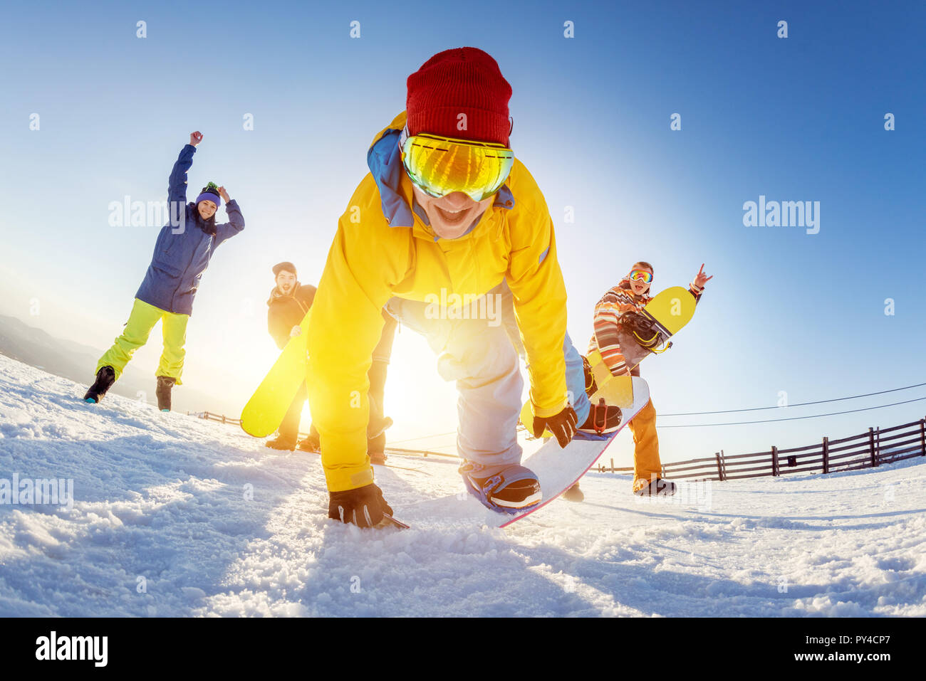 Funny photo with with friends at ski resort. Snowboarders are having fun in playful poses Stock Photo