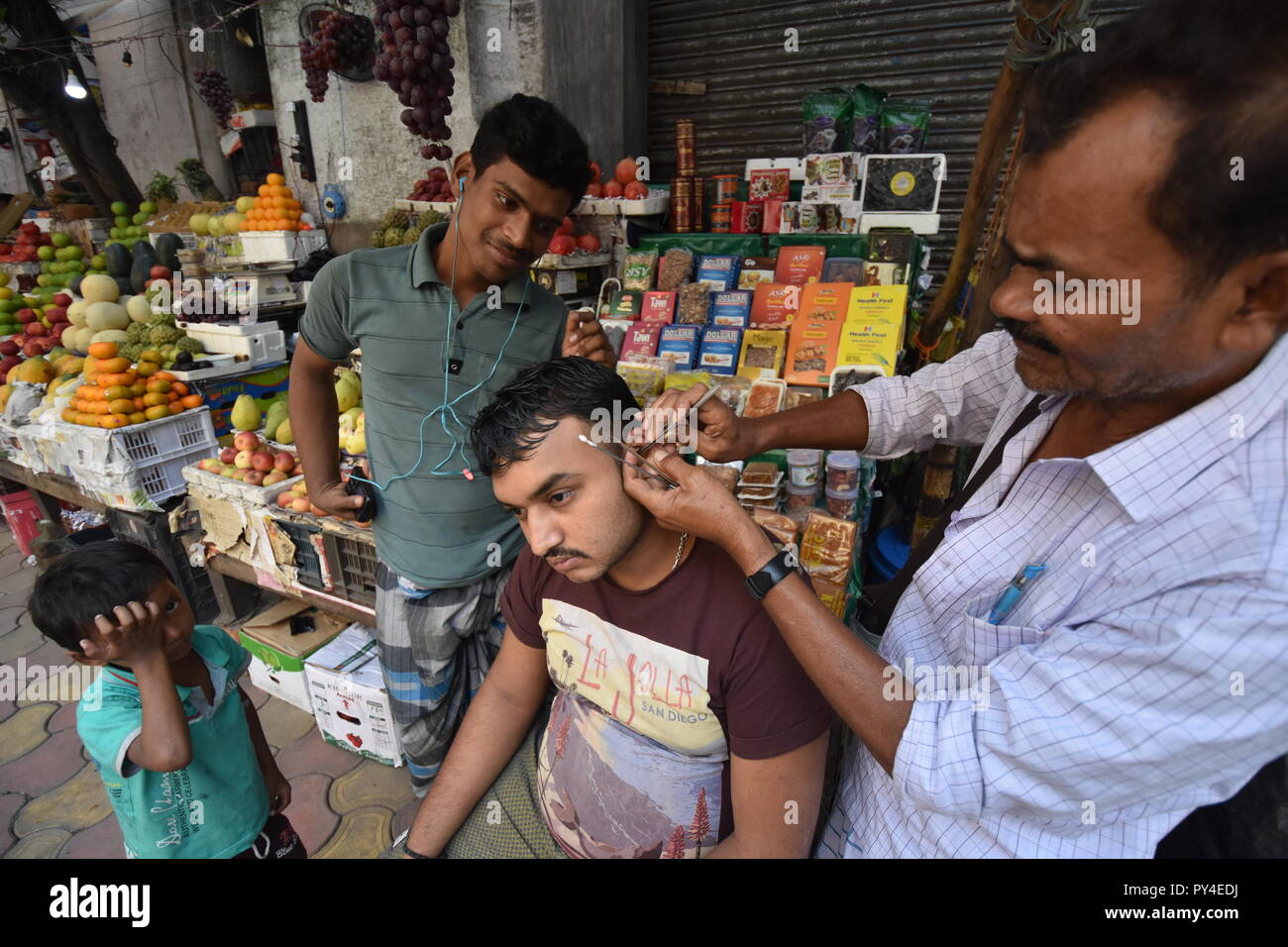 Roadside ear wax cleaning at British India Street in Kolkata, India