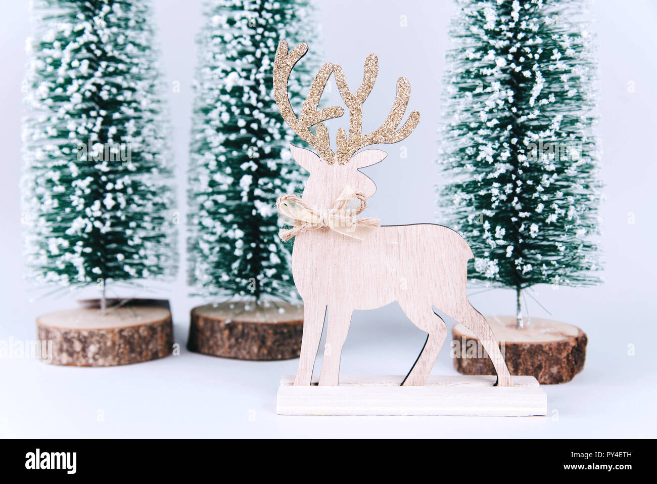 Christmas wooden tree with reindeer over light blue background Stock ...