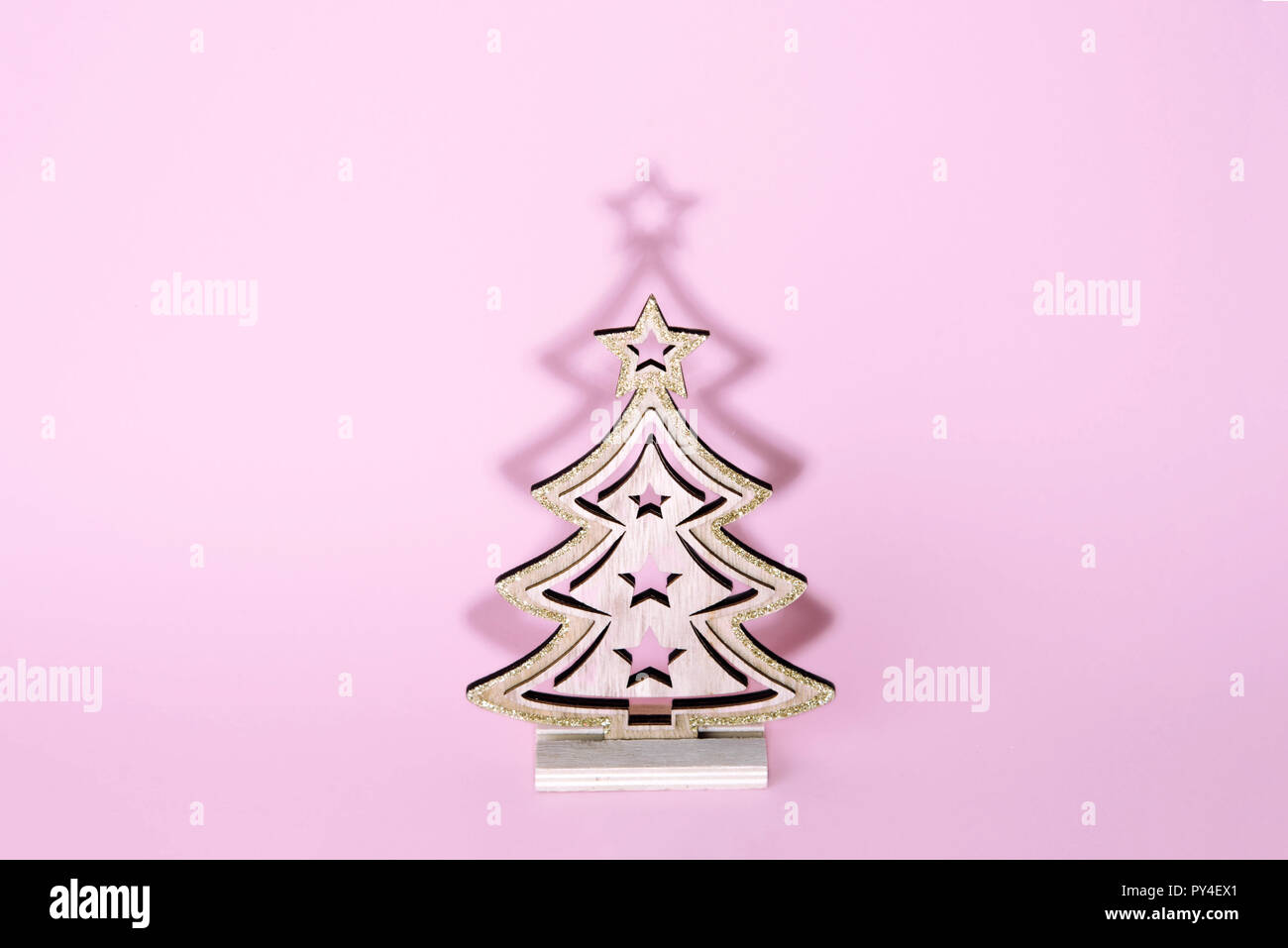 Christmas wooden tree over light pink background Stock Photo - Alamy