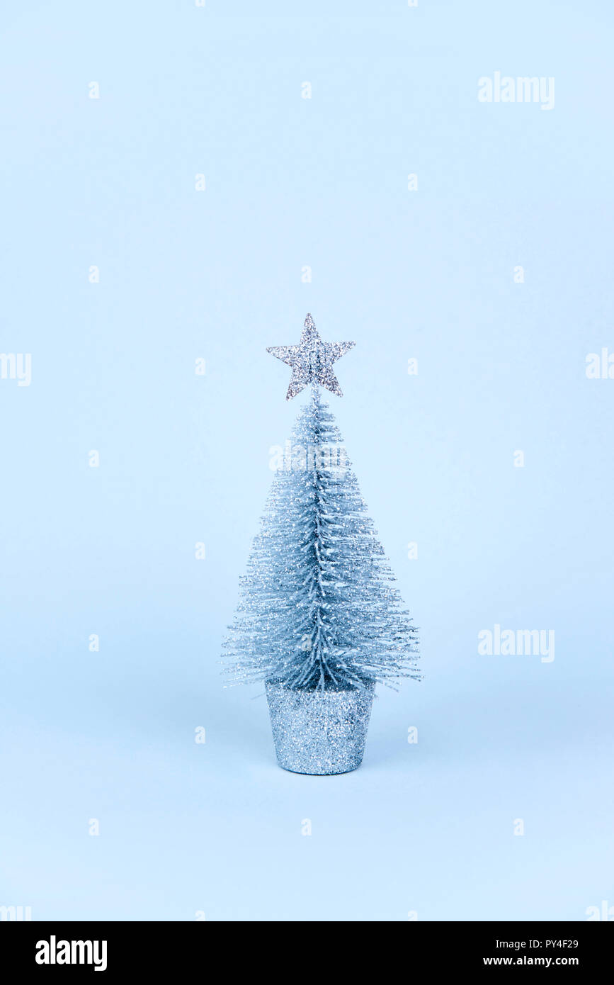 Christmas tree over light blue background Stock Photo - Alamy