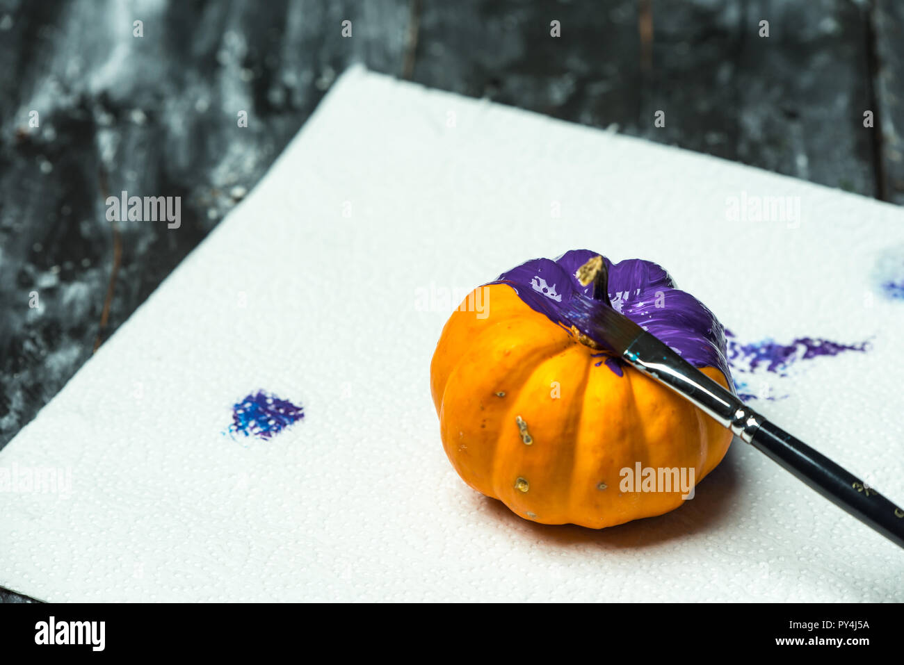 do it yourself, painting Halloween pumpkins in purple Stock Photo