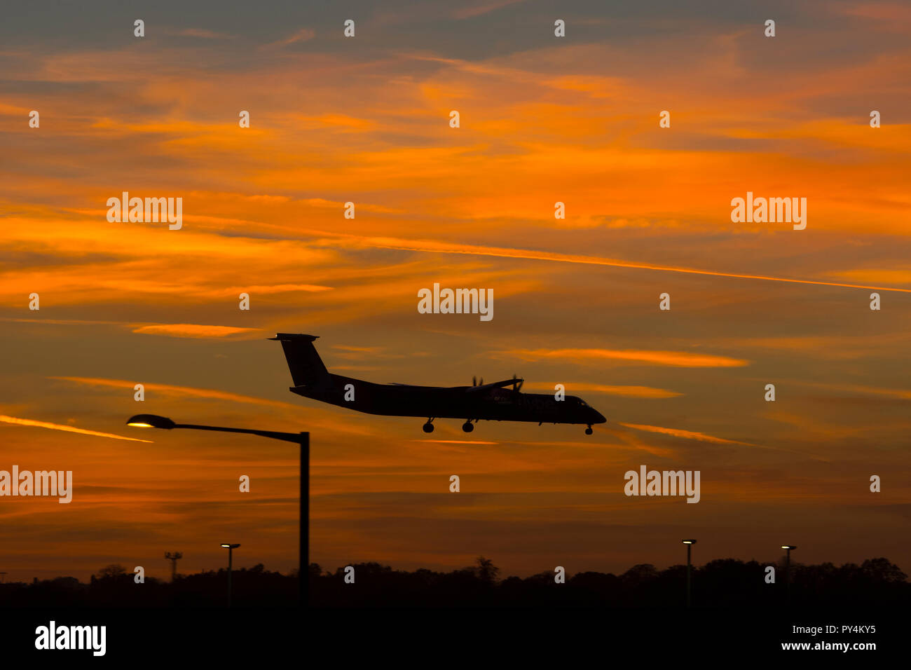 Flybe Bombardier Dash 8 landing at sunset, Birmingham Airport, UK Stock Photo
