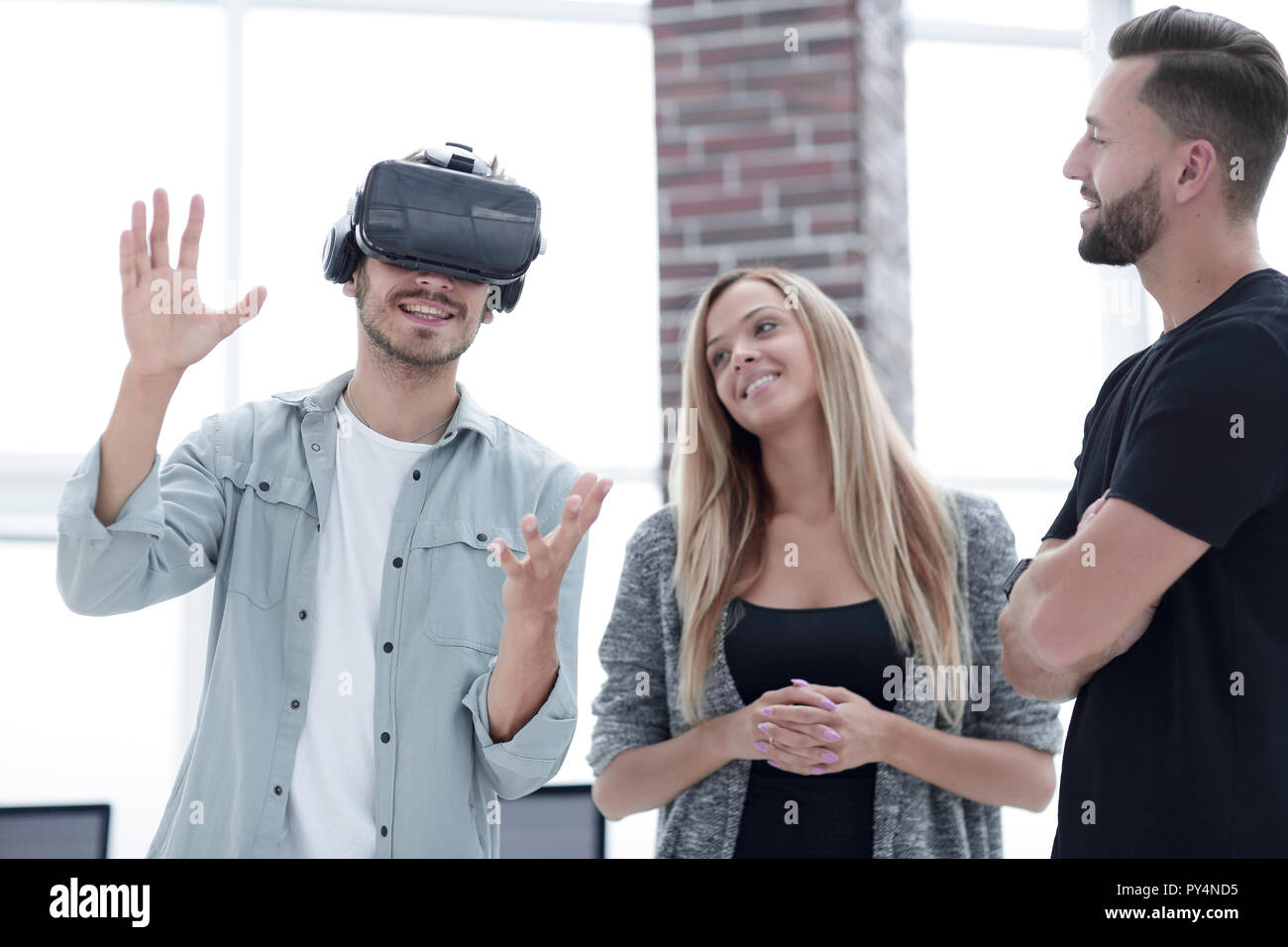 Positive colleagues testing virtual reality device Stock Photo