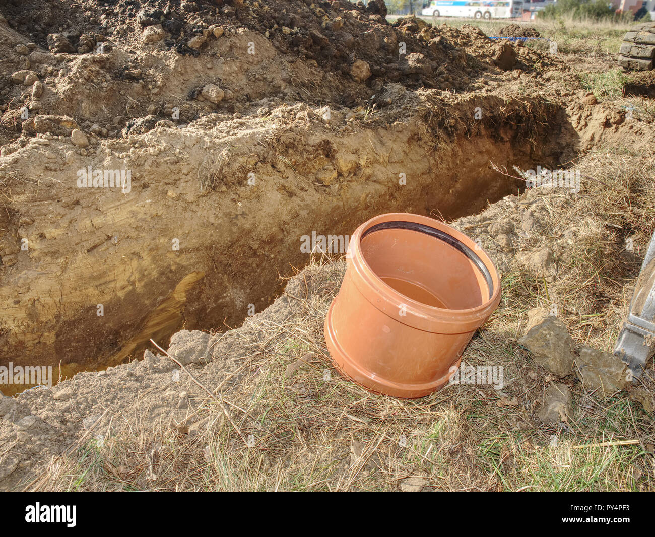 Big PVC fittings on ground at trench. Plumber tube for drink water