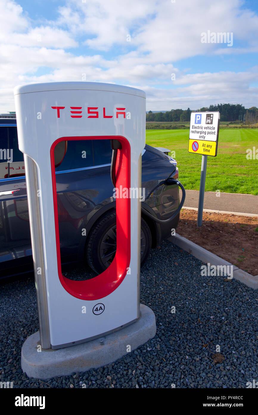 Charging car at Tesla. Electric charging point, UK Stock Photo Alamy