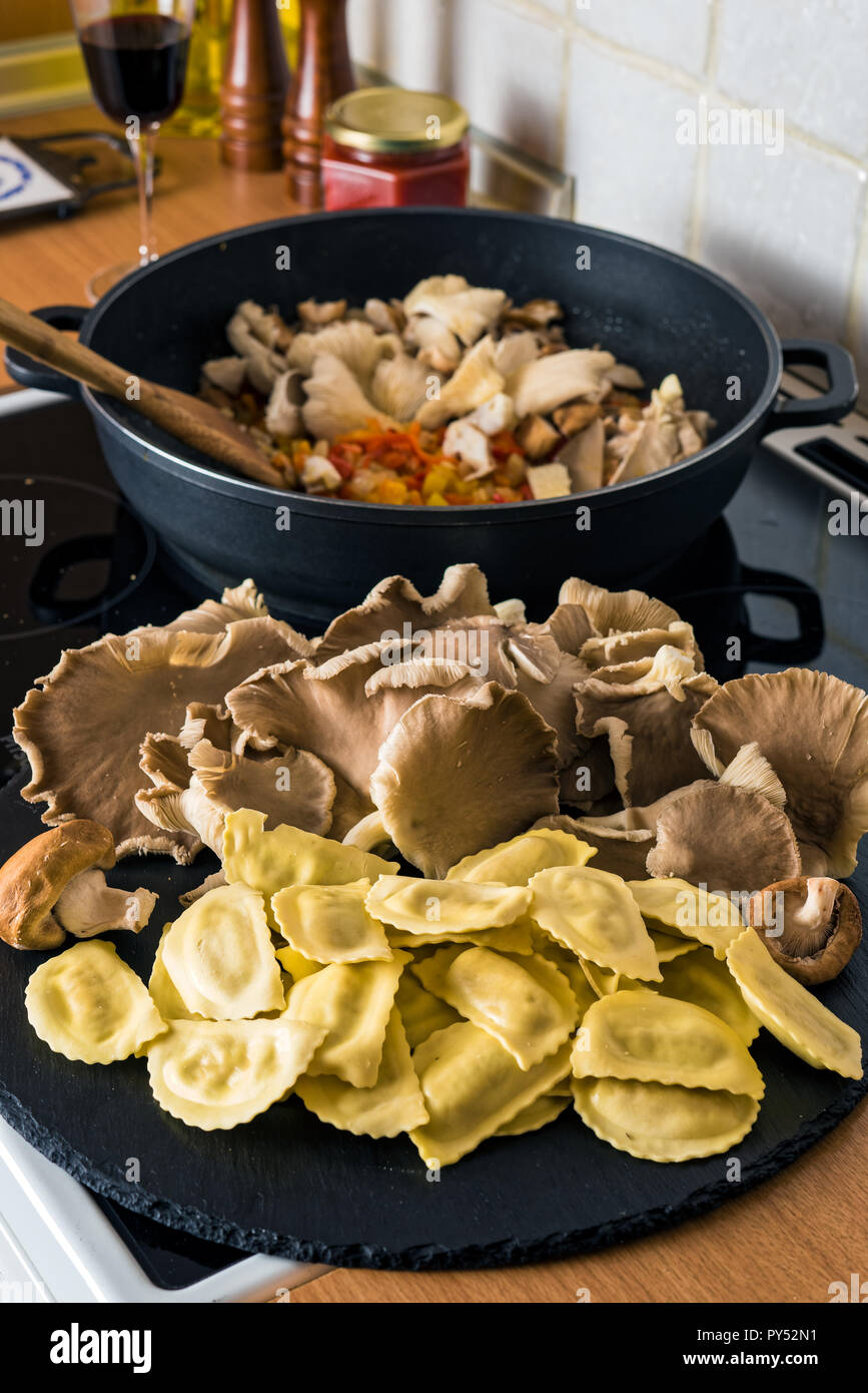 Raw ravioli and mushrooms in a kitchen during cooking Stock Photo - Alamy