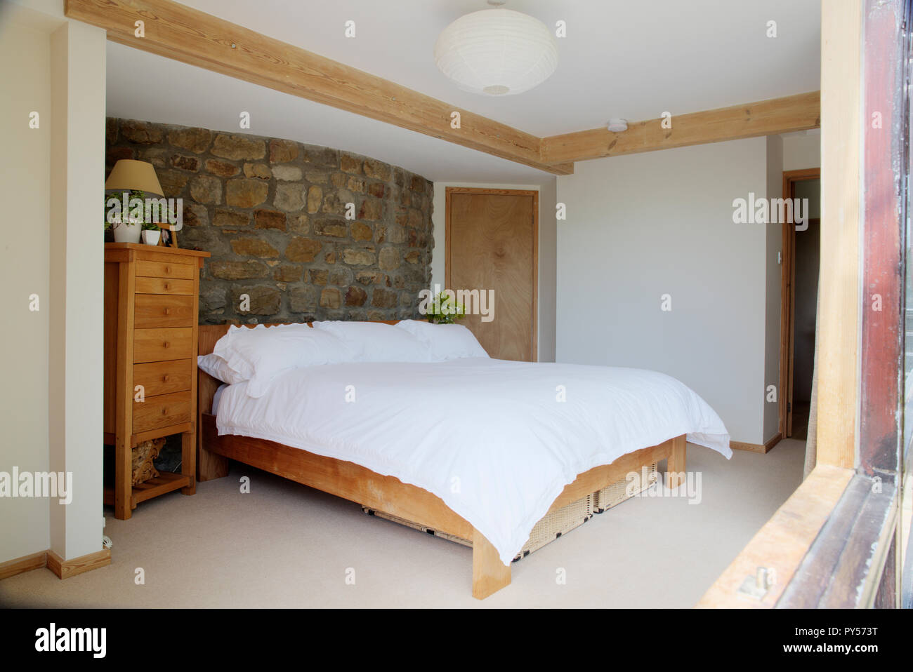 A Wide View Shot Of A Modern Bedroom Interior A Large Bed Is In The Centre Of The Image Stock Photo Alamy