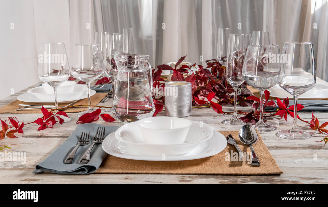 white plate table setting on wooden table. Stock Photo