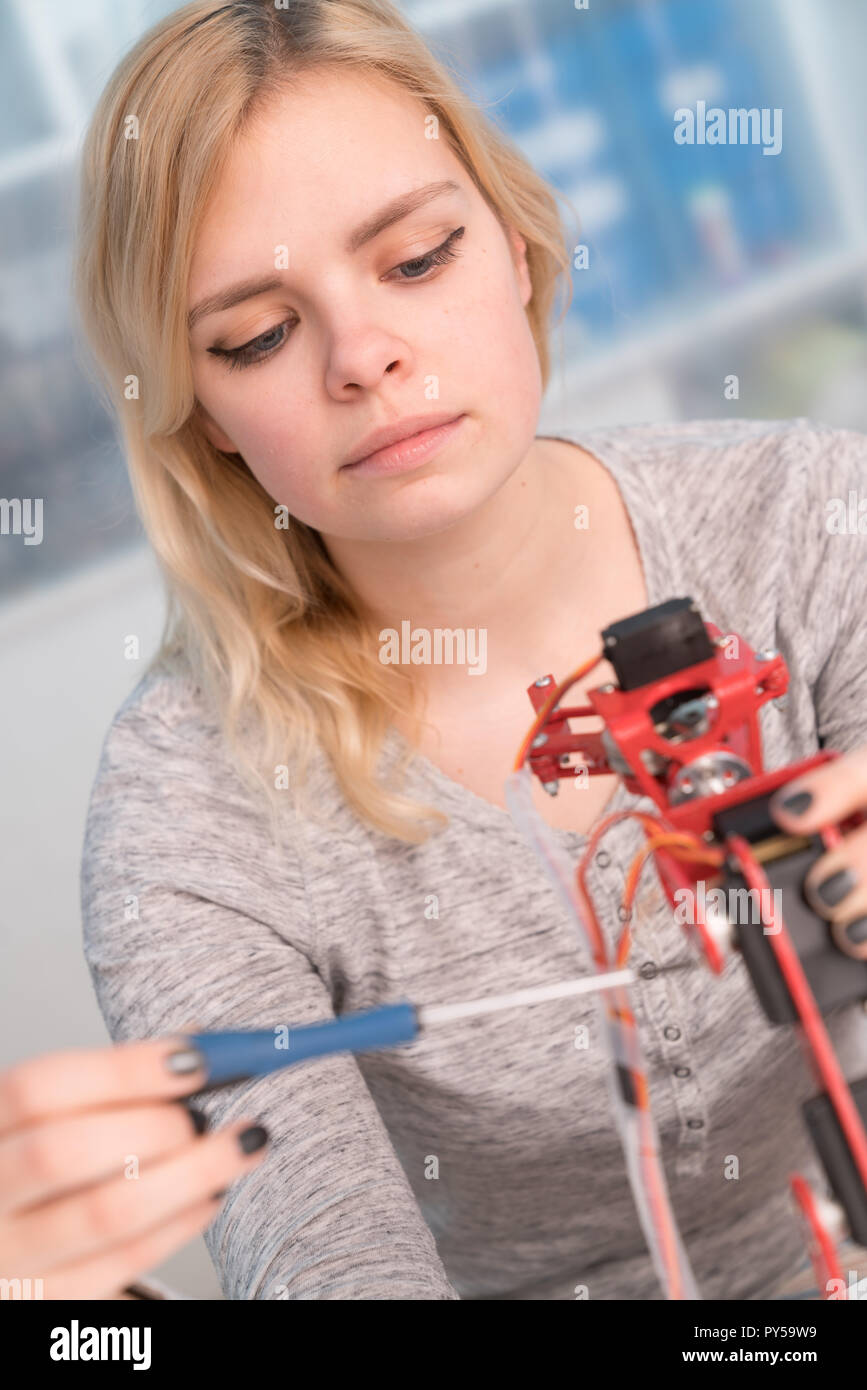 young engineer adjusting intelligence toy robot Stock Photo