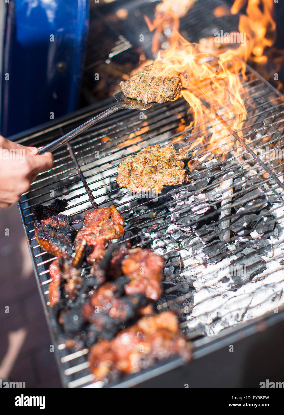 Food Connections 2015.  A burger is cooked on a large outdoors BBQ at a food festival in Bristol, England. Stock Photo