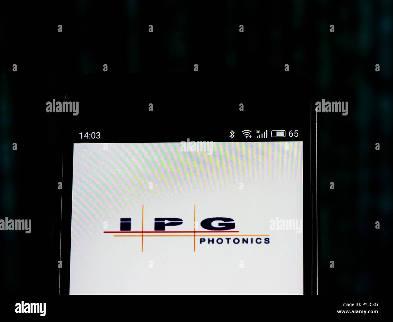 IPG Photonics company logo seen displayed on smart phone. IPG Photonics is a manufacturer of fiber lasers and fiber amplifiers. Stock Photo