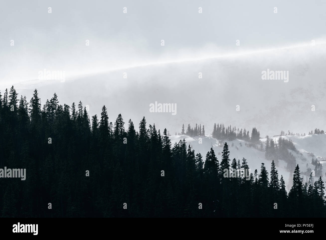 Severe winter weather blows snow over mountain peak Stock Photo - Alamy