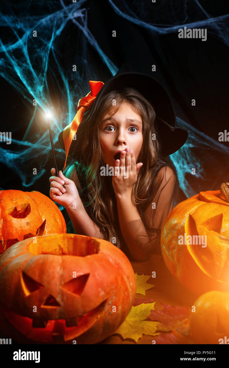 Halloween Witch concept - little witch child enjoy playing with magic