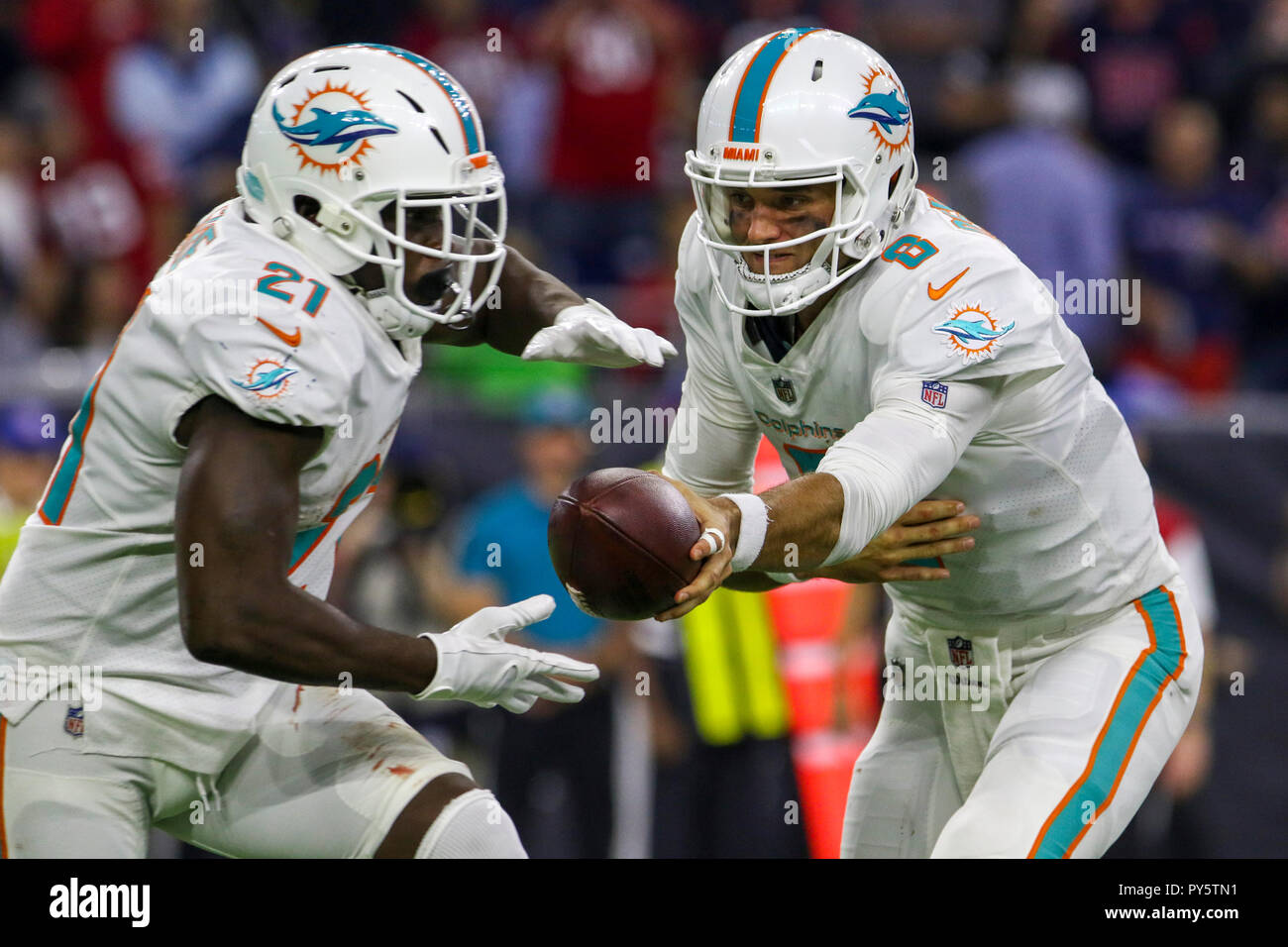 Houston, TX, USA. 25th Oct, 2018. Miami Dolphins quarterback Brock Osweiler (8) hands the ball off to running back Frank Gore (21) during the third quarter at NRG Stadium in Houston, TX. John Glaser/CSM/Alamy Live News Stock Photo