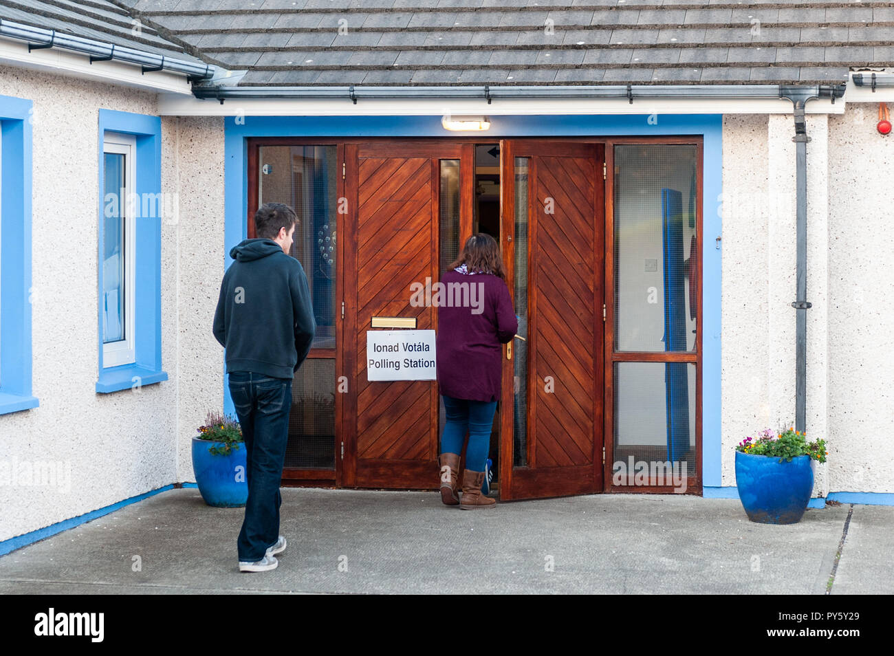 Schull, West Cork, Ireland. 26th Oct, 2018. Two people head into Schull Polling Station at Scoil Mhuire National School to cast their votes in the presidential and blasphemy referendums. Turnout in rural areas is very low so far this morning. Credit: Andy Gibson/Alamy Live News. Stock Photo