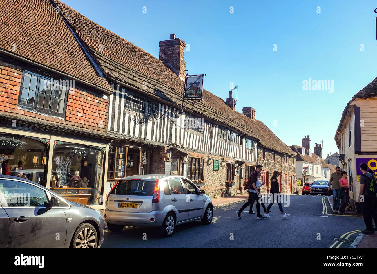 Traffic and pedestrians in the picturesque village of Alfriston East Sussex Britain UK -  Photograph taken by Simon Dack Stock Photo