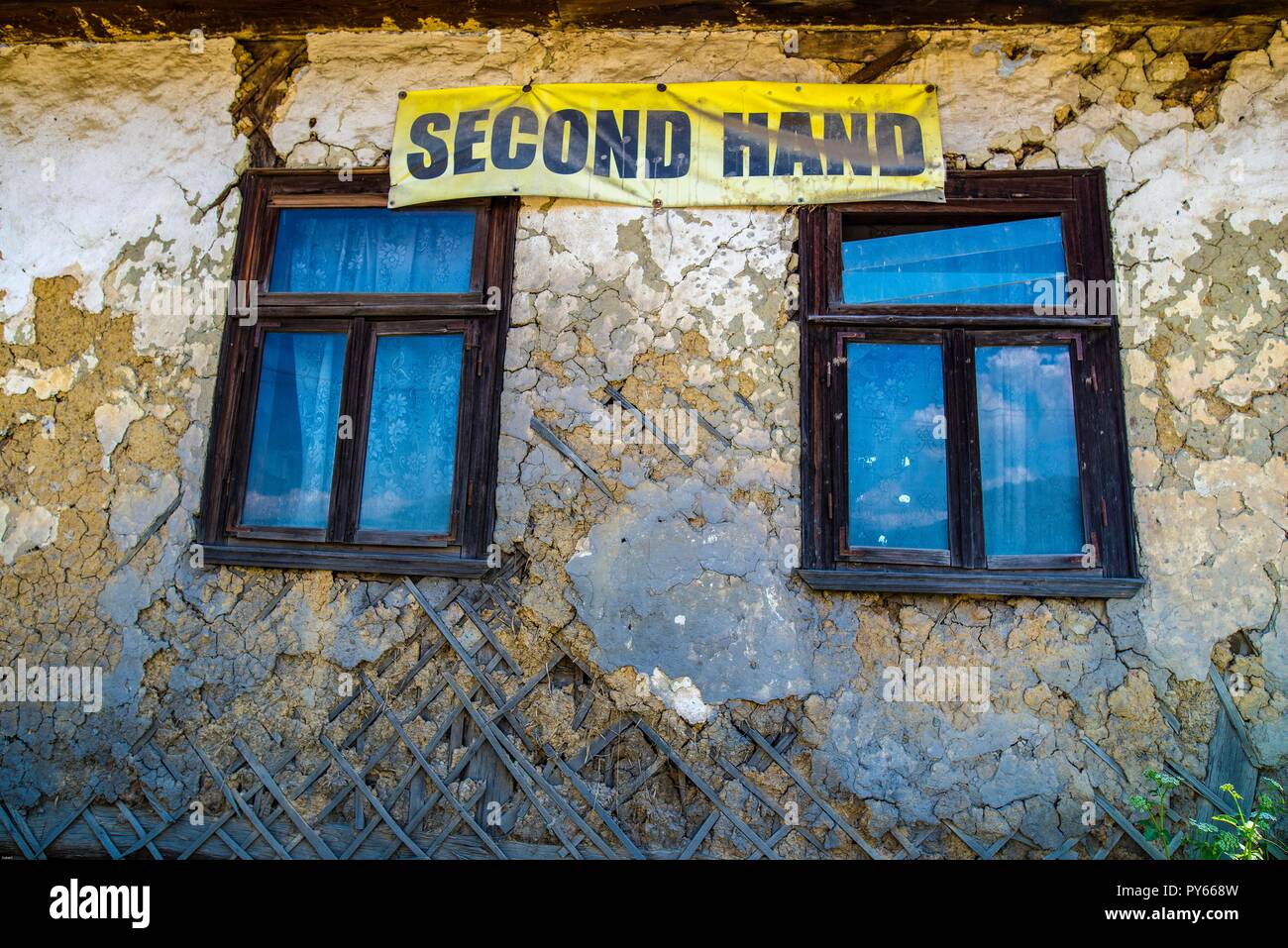 The comment  'second hand' on a traditional run down building near Barsana in Romania is hardly necessary, maybe it is only sarcastic. Stock Photo