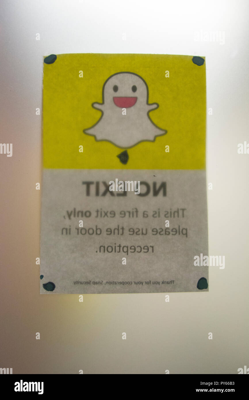 Snapchat's ghost logo and app icon on exit door at Snapchat HQ in London's Soho district. Stock Photo