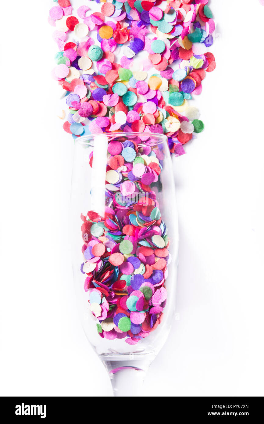 Champagne glass with confetti isolated on white background Stock Photo
