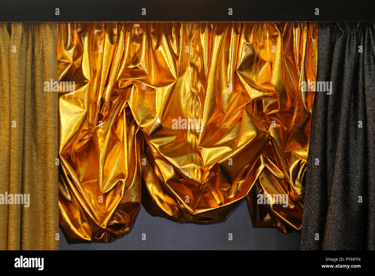 Shiny Gold Curtain Dropped Half Way To The Floor Stock Photo
