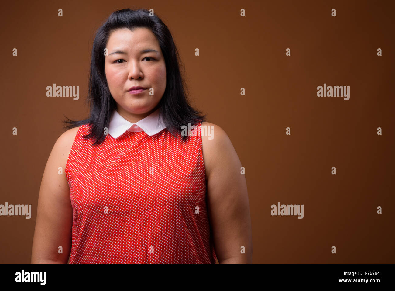 Beautiful overweight Asian woman looking at camera Stock Photo