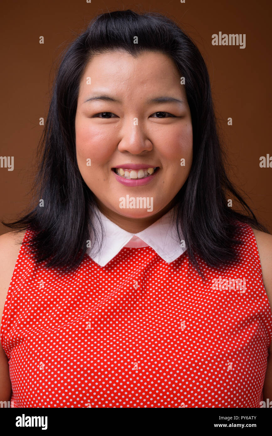 Face of beautiful overweight Asian woman smiling Stock Photo