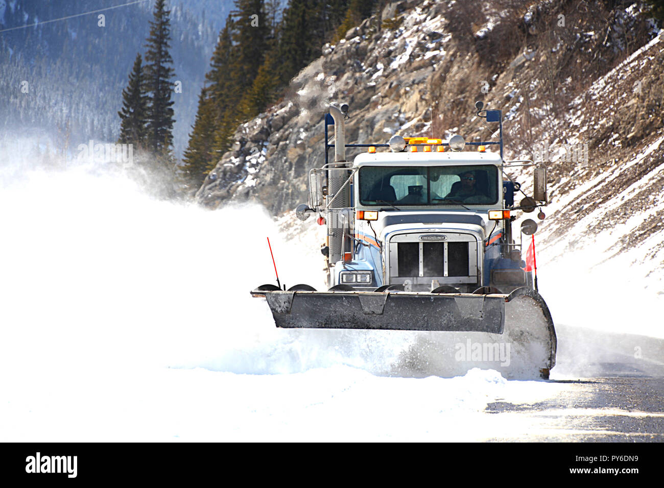 Snow plowing the mountain roads in Kananaskis Provincial Park, Alberta, Canada Stock Photo