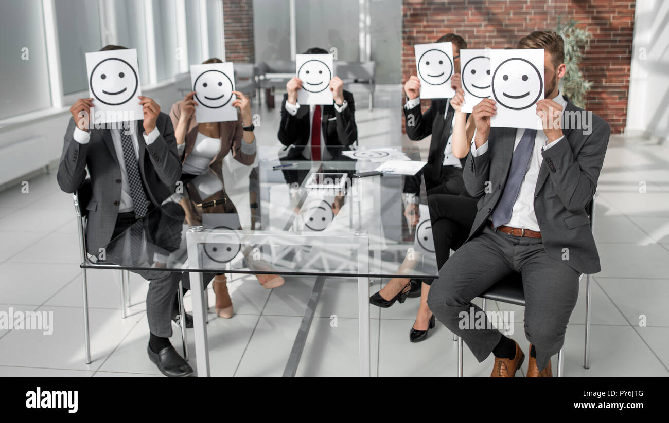 Business Team holding a paper with a positive smiley Stock Photo