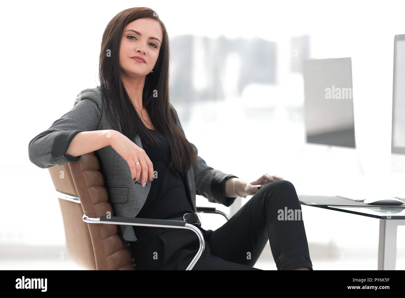young business woman sitting at her Desk Stock Photo - Alamy