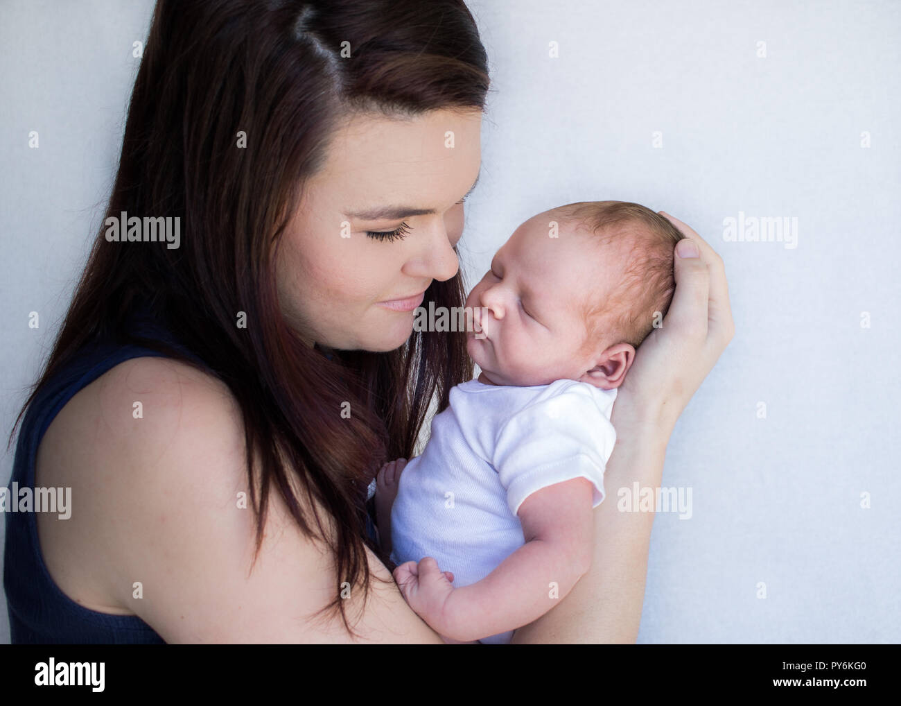 Woman holding up baby hi-res stock photography and images - Alamy