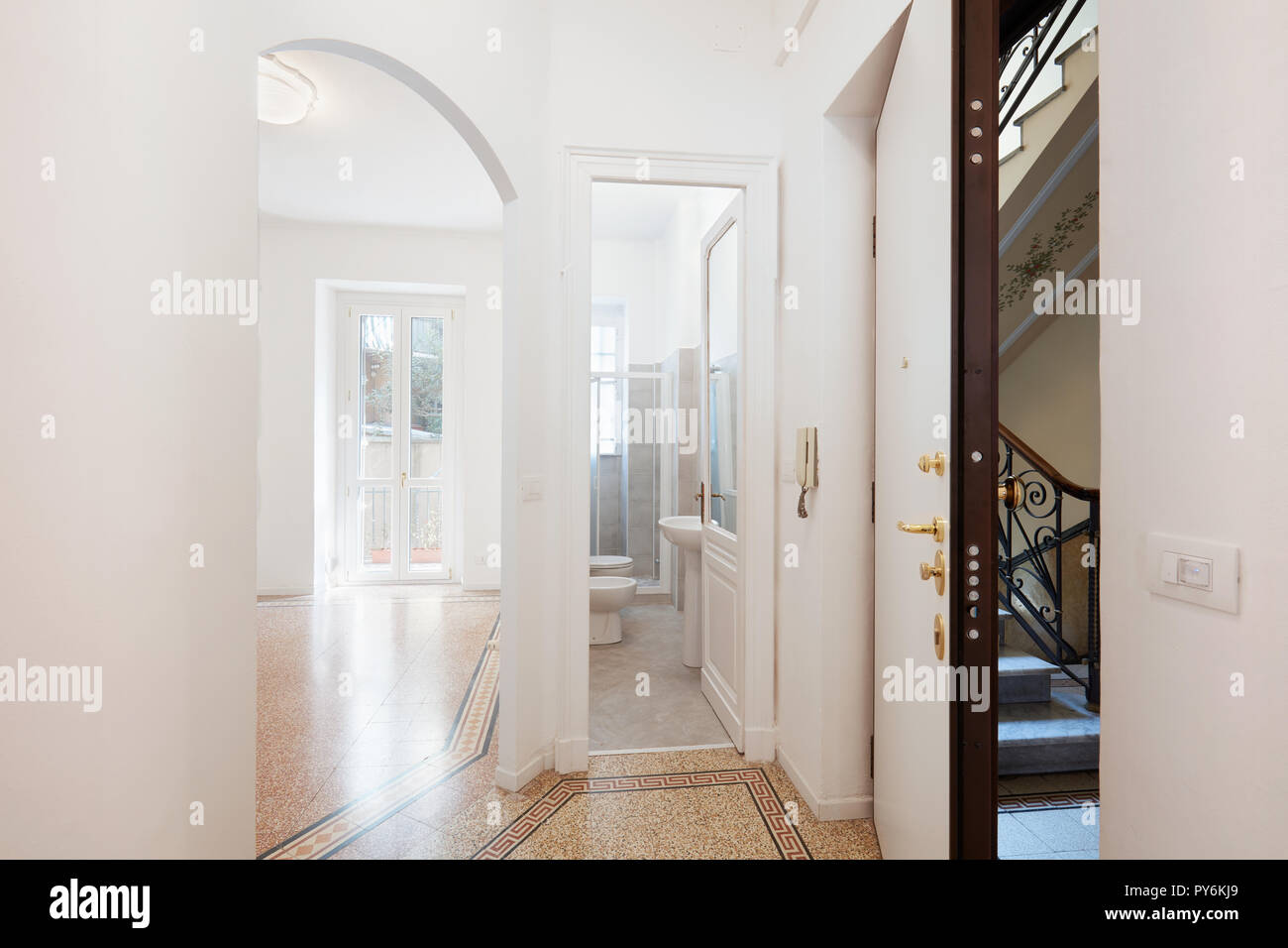 Empty renovated apartment entrance with security door, bathroom and living room Stock Photo