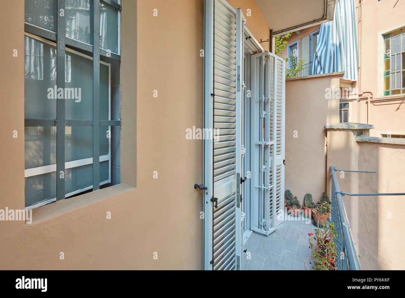 Balcony with gray floor and new blind and railings Stock Photo
