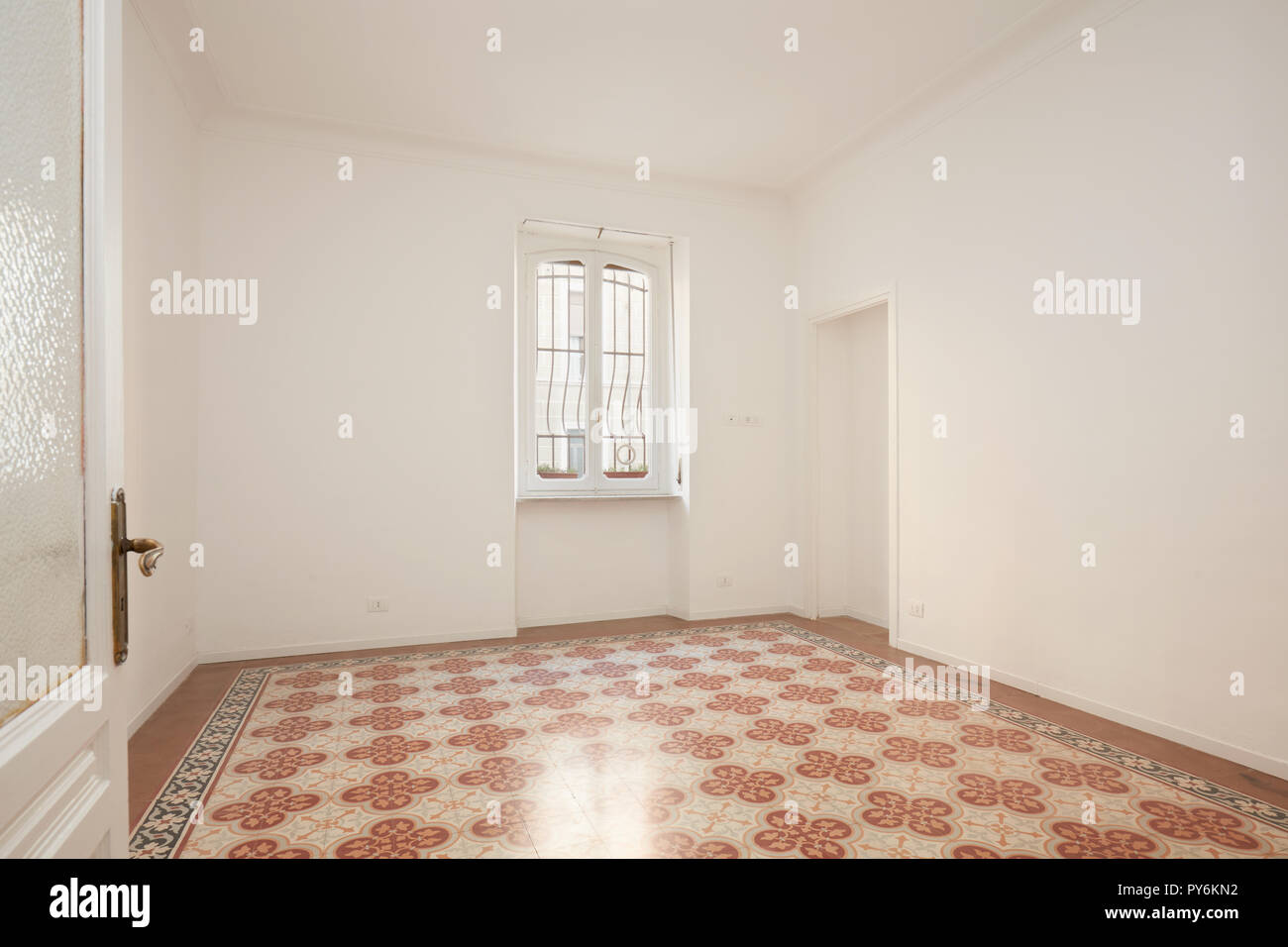 Open door and white, empty room in renovated apartment Stock Photo