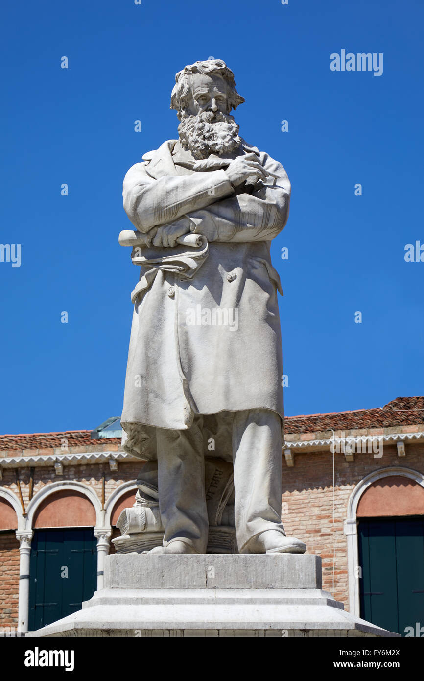 Niccolo Tommaseo statue in Venice by Francesco Barzaghi (1839-1892) in a sunny summer day in Italy Stock Photo
