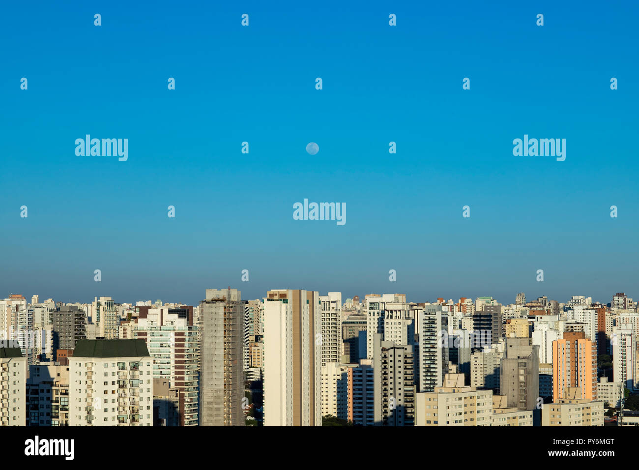 Moon on a sunny day in the city. Moon on a sunny day in the Sao Paulo city, Brazil. Stock Photo