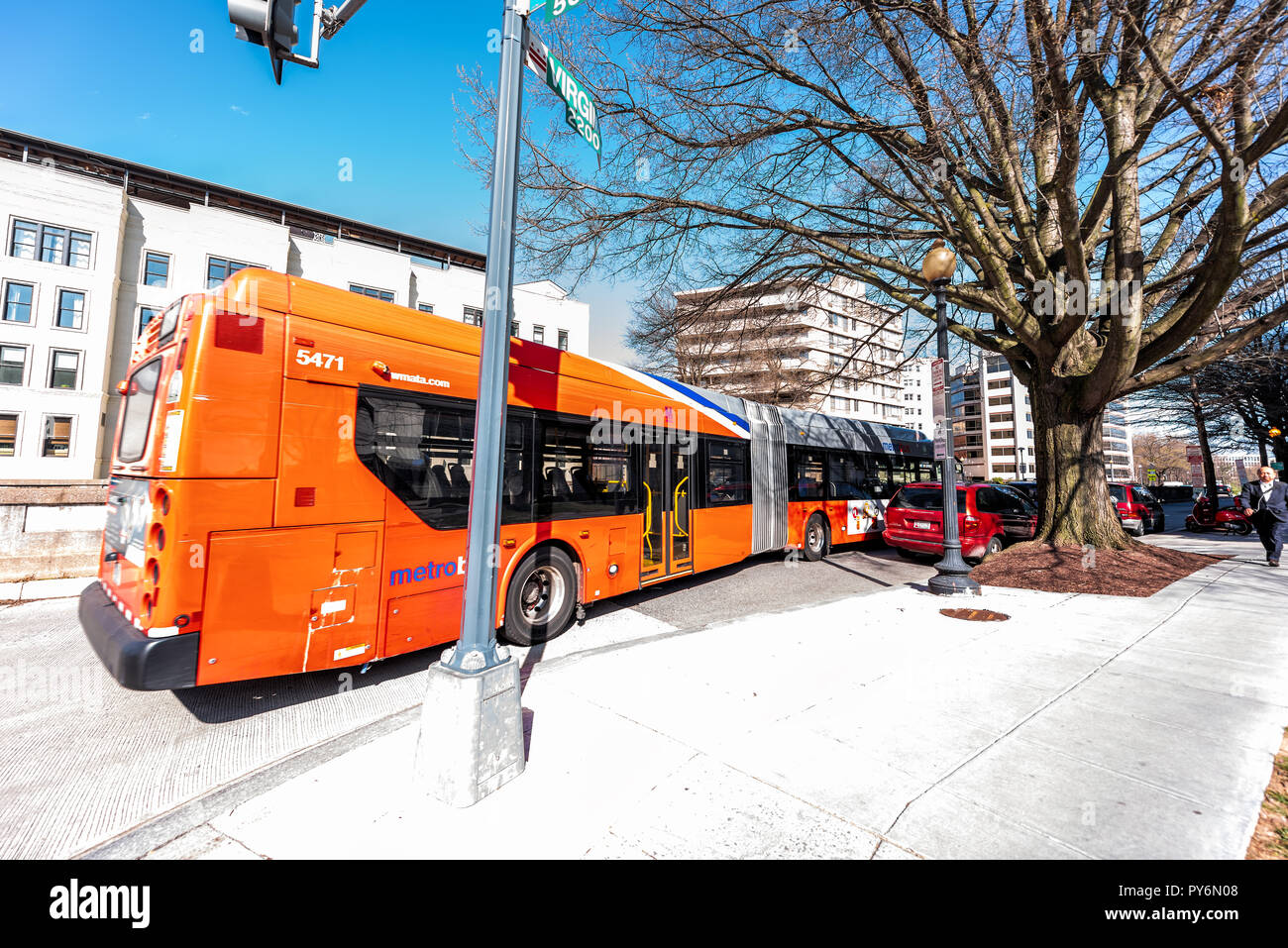 Washington DC, USA - April 5, 2018: Capital red orange bus Metrobus metro big public transport vehicle waiting for passangers on Virginia avenue stree Stock Photo