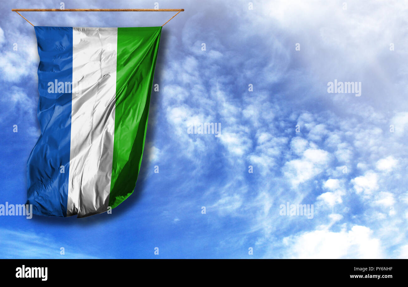 Flag of Sierra Leone. Vertical flag, against blue sky with place for ...