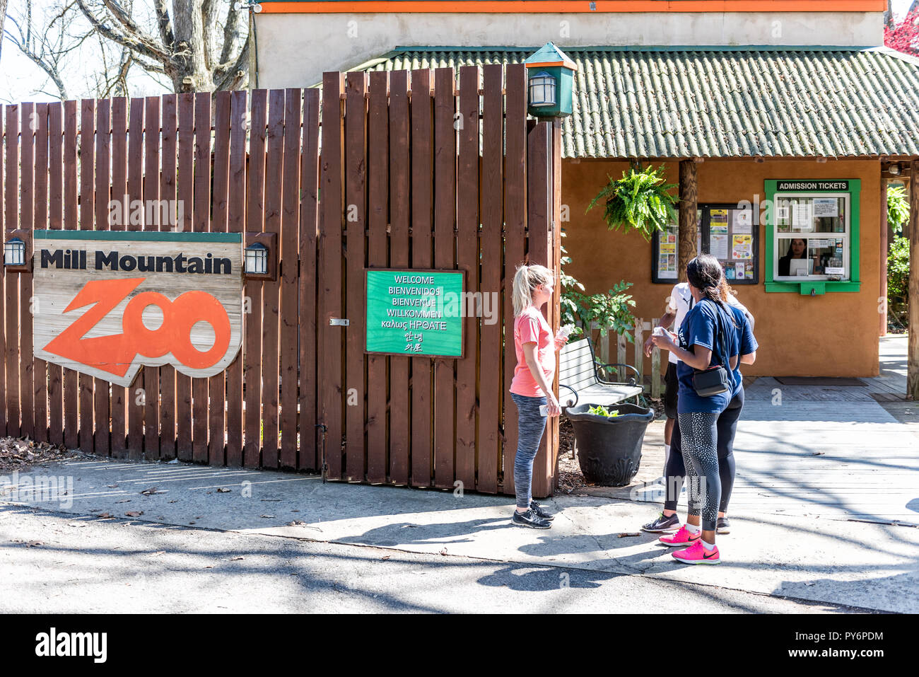 Roanoke, USA - April 18, 2018: Mill Mountain Park in Virginia during spring with sign for Zoo, young people during sunny day, entrance Stock Photo