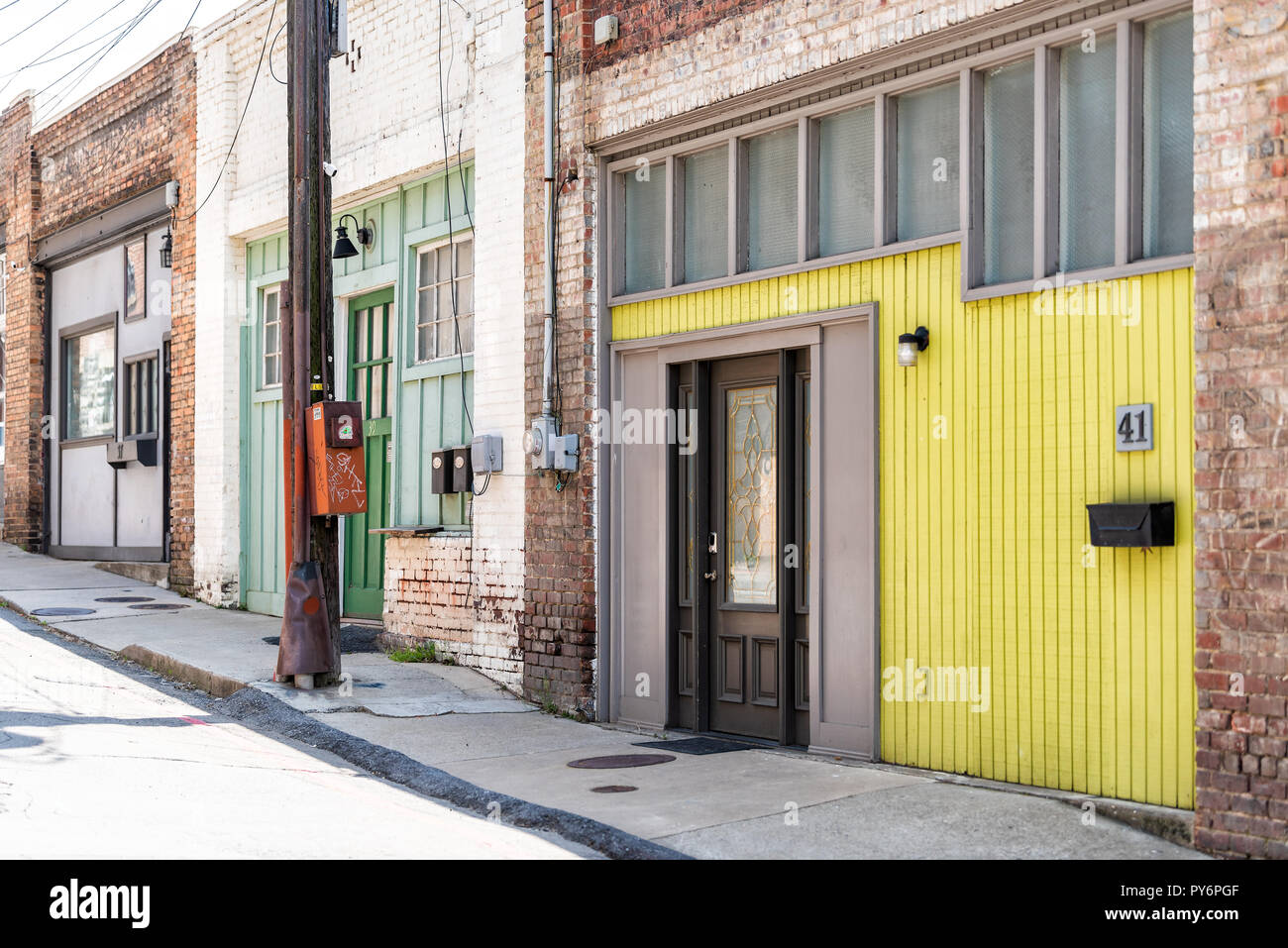 Asheville, USA - April 19, 2018: Downtown old town street in North Carolina NC town, city with nobody, yellow building Stock Photo