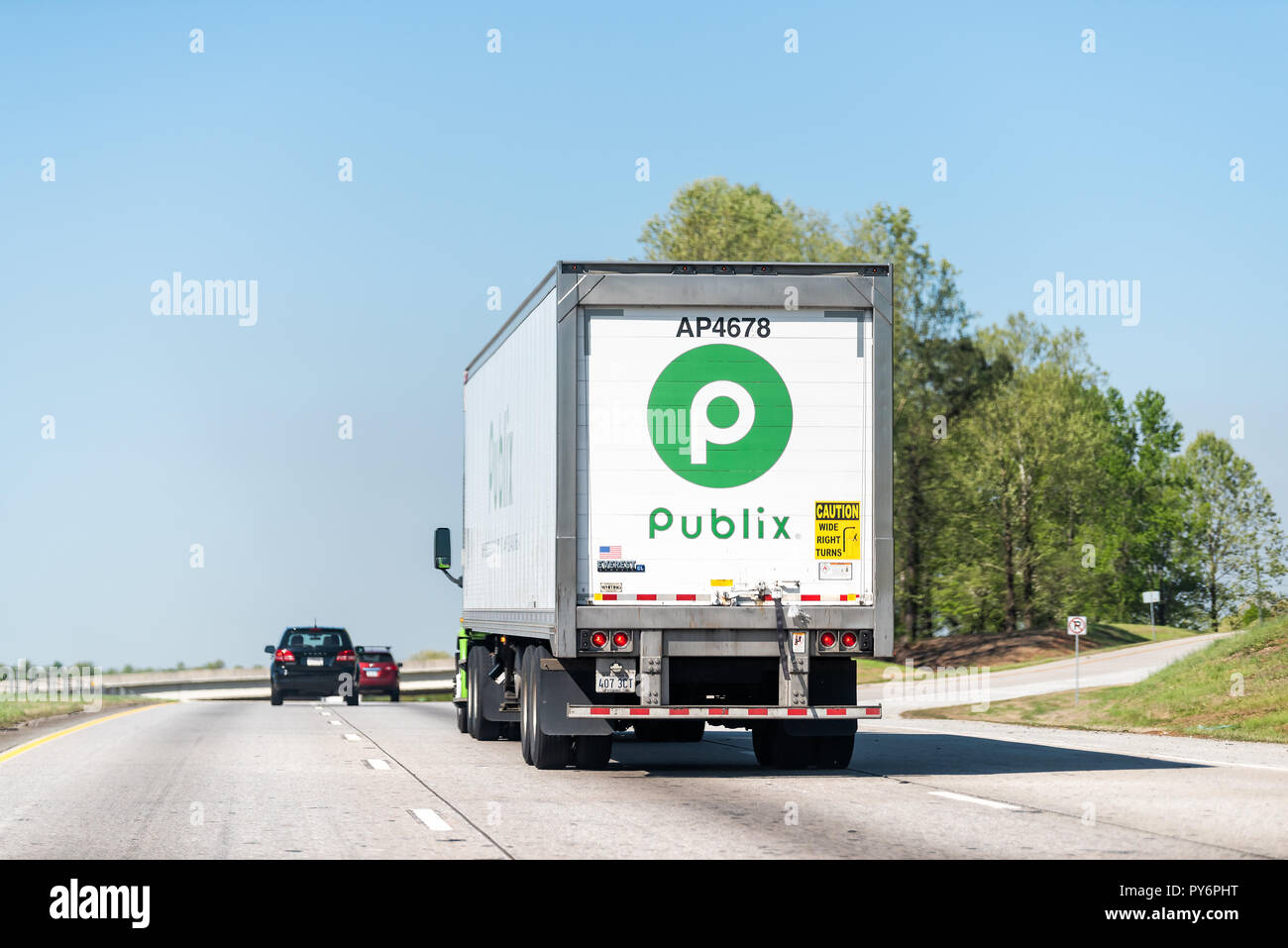 Atlanta, USA - April 20, 2018: Back of green Publix grocery store delivery truck closeup on highway road with sign Stock Photo