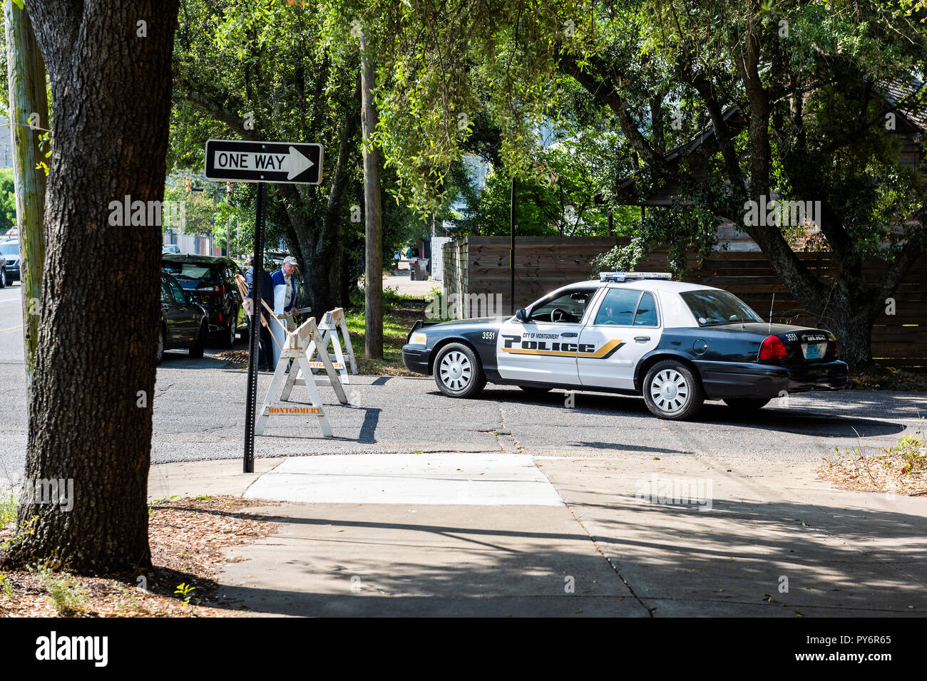 Montgomery, USA - April 21, 2018: Alabama city police officer car on street, with sign, people walking on sidewalk Stock Photo