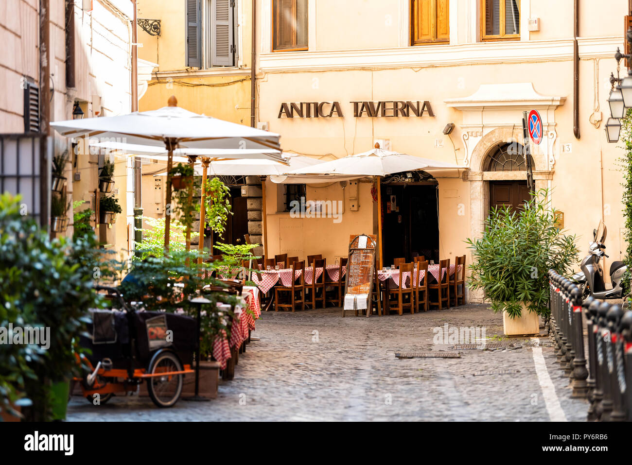 Rome, Italy - September 4, 2018: Italian restaurant tables, chairs, outside in traditional style, nobody on street cafe in historic city in morning, A Stock Photo