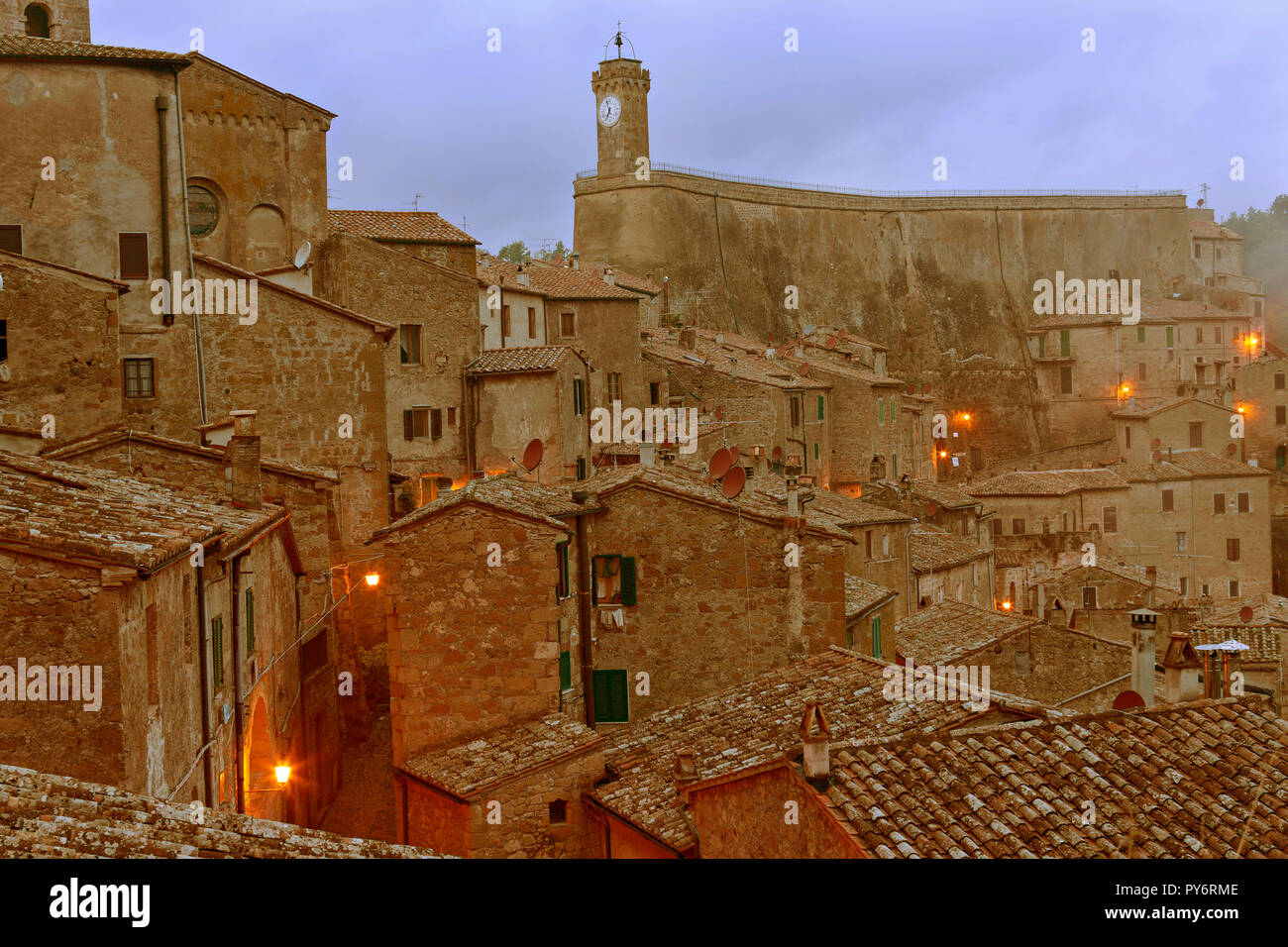 Sorano in early evening light with the Clock Tower of Masso Leopoldino ...