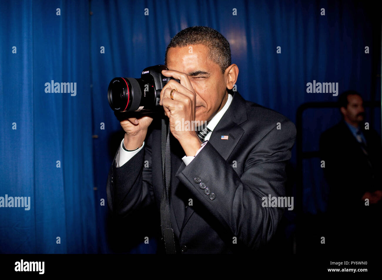 President Barack Obama takes aim with a photographer's camera backstage prior to remarks about providing mortgage payment relief for responsible homeowners. Dobson High School. Mesa, Arizona 2/18/09.  Official White House Photo by Pete Souza Stock Photo