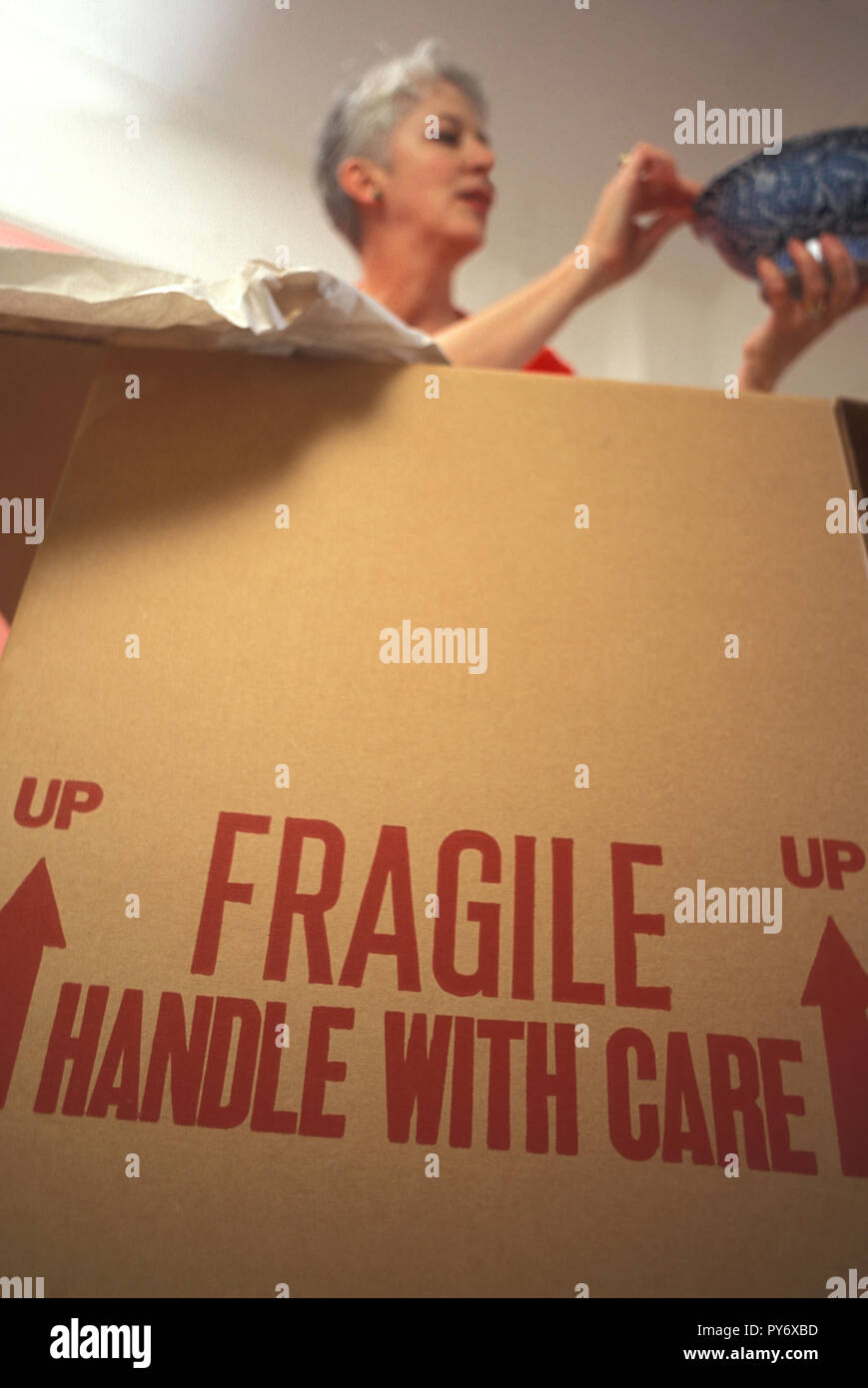 Senior woman unpacking fragile items, USA Stock Photo - Alamy